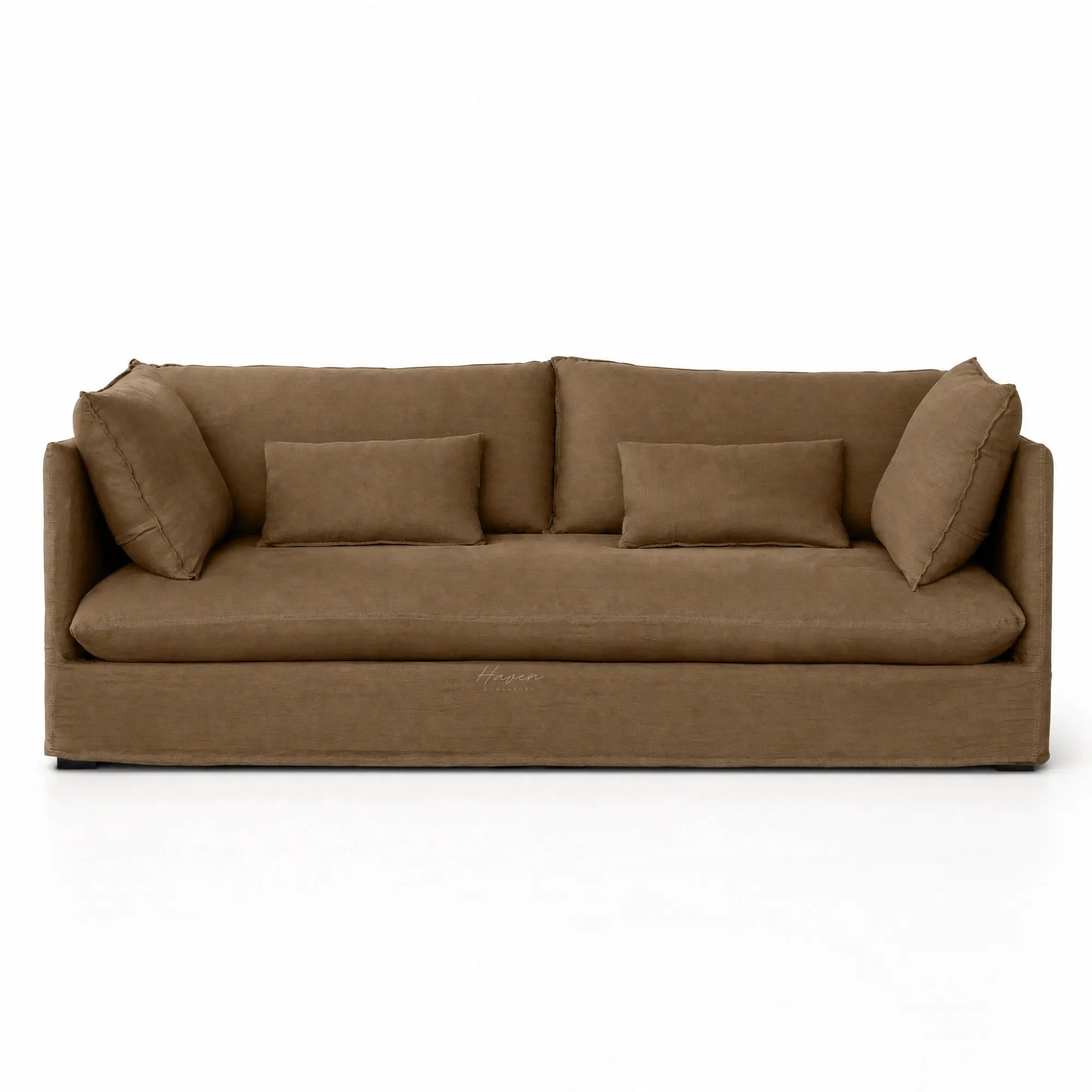 Low-set mocha linen slipcover sofa featuring relaxed tailored fabric, loose back cushions, and rectangular throw pillows.