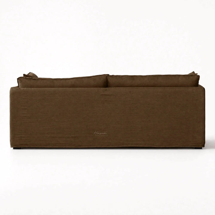 Back view of Nella Mocha Linen Slipcover Sofa featuring a low-set silhouette, loose cushions, and tailored 100% linen fabric.