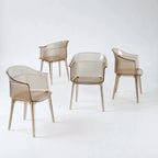 Set of four translucent amber polycarbonate chairs featuring a sculptural wraparound silhouette and fine vertical texture details.