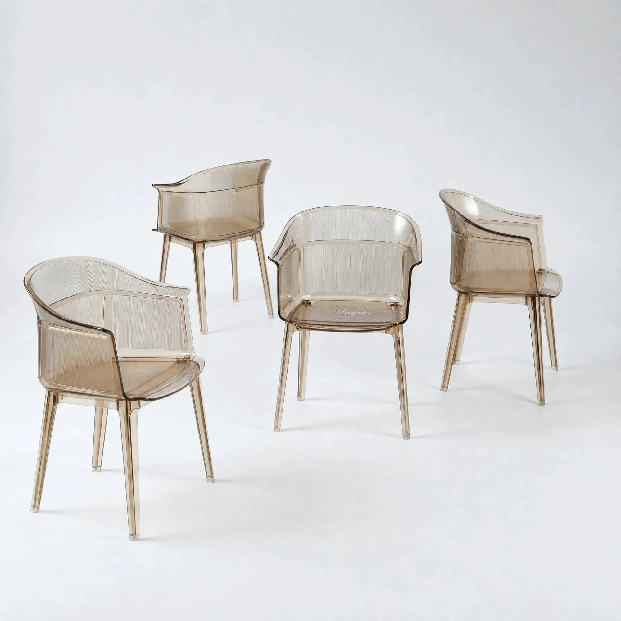 Set of four translucent amber polycarbonate chairs featuring a sculptural wraparound silhouette and fine vertical texture details.