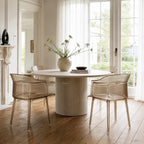Set of four translucent amber polycarbonate chairs with vertical ribbing and wraparound silhouette around a round stone table.