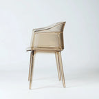 Translucent amber polycarbonate chair with sculptural wraparound silhouette and fine vertical texture detailing.