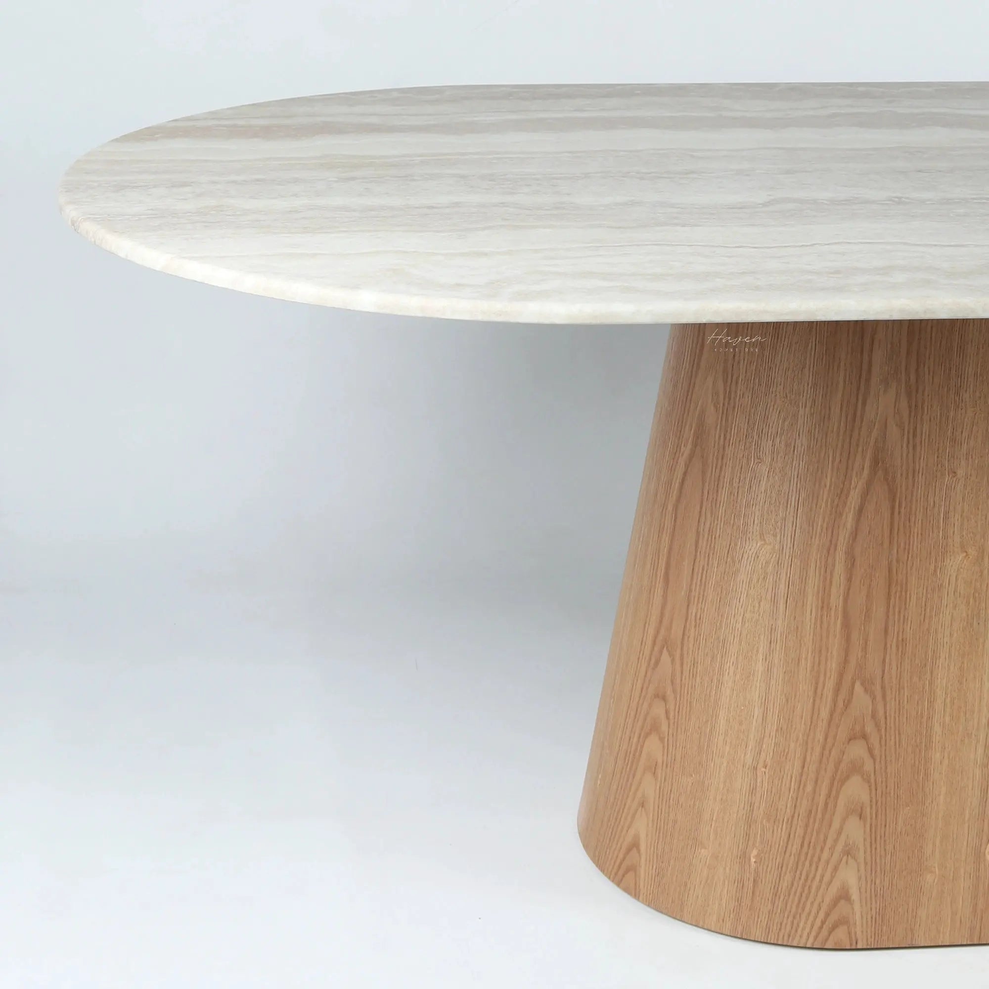 Aalto dining table featuring a rounded faux marble top with subtle veining and a tapered natural timber pedestal base.