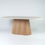 Oval faux marble dining table with a tapered wooden pedestal base, featuring a modernist sculptural silhouette.