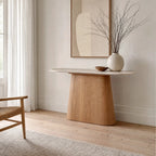 Aalto Console with rounded faux-marble top and sculptural oak-toned veneer base in a serene, minimalist room.