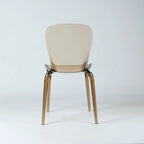 Amber transparent polycarbonate dining chair with softly curved back and slender legs.