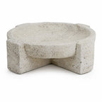Textured concrete bowl with a sculptural, irregular form and weathered stone appearance for coastal decor.