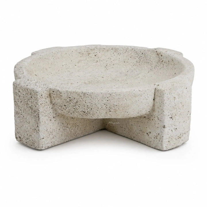 Textured concrete bowl with a sculptural, irregular form and weathered stone appearance for coastal decor.
