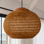 Round woven banana leaf pendant light with teak top detail. Open weave allows light to filter through, adding warm texture to any room.