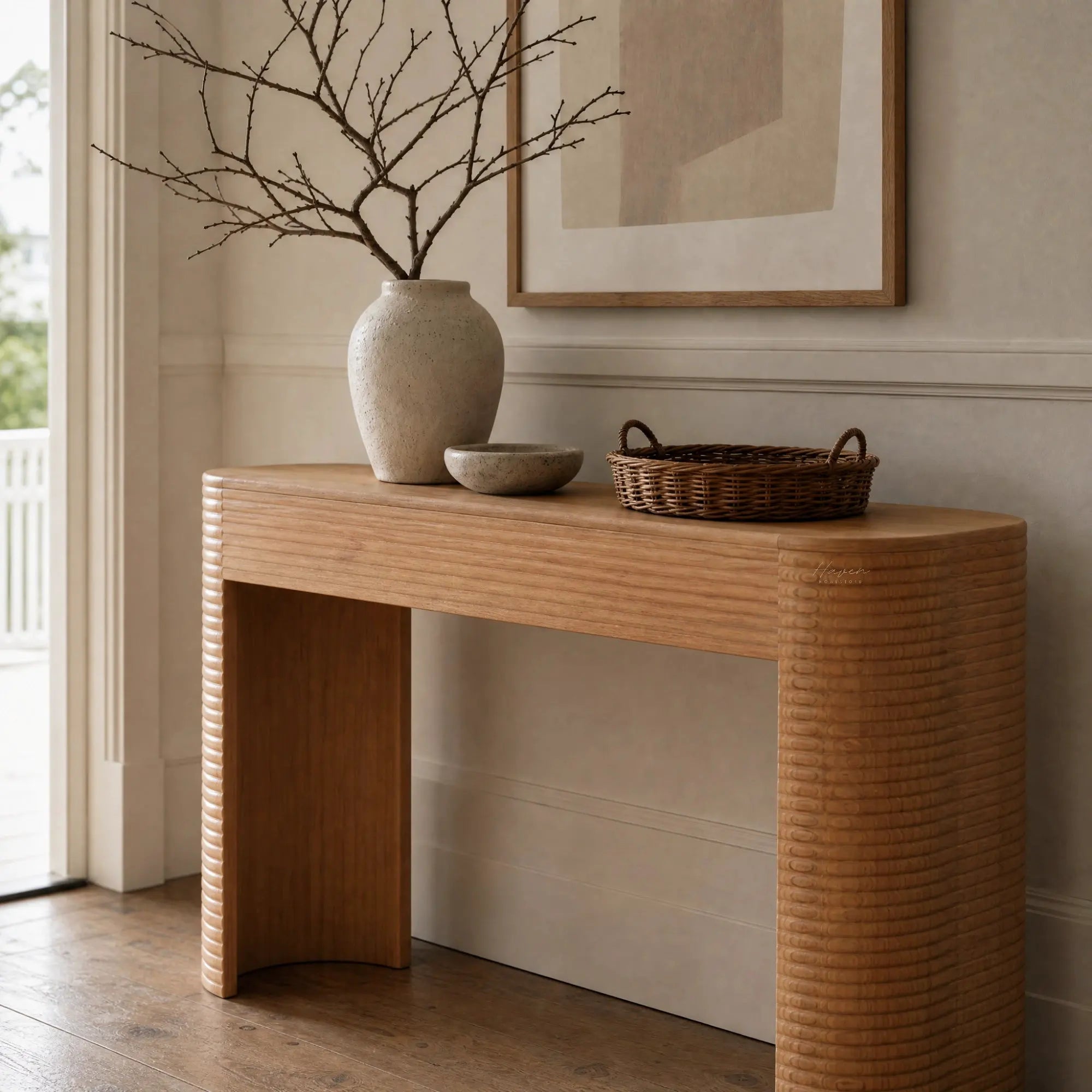 Elva Console in mindi timber with rounded silhouette, linear carved detailing, and horizontal textured legs.