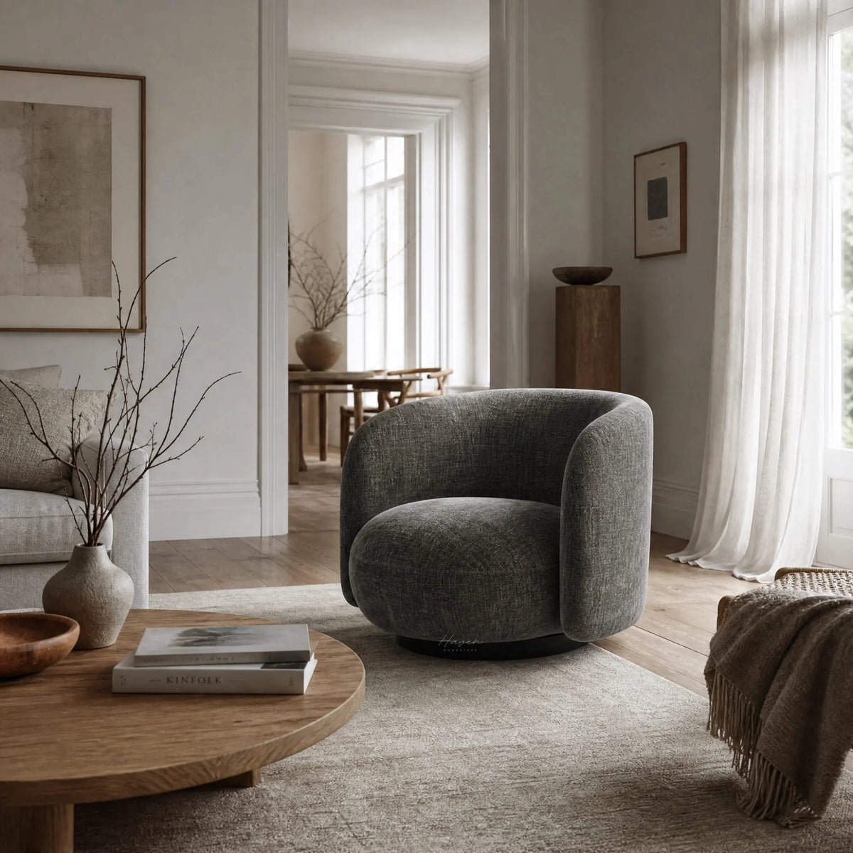 Moss green textured swivel chair with a low, rounded profile and enveloping back, grounded by a dark base in a sunlit living room.