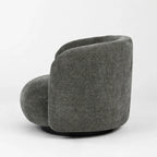 Rear view of moss grey swivel chair featuring a rounded, enveloping back, textured polyester fabric, and dark base.
