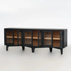 Long, low profile dark timber sideboard with rounded glass doors open to reveal warm ash wood interior shelving.