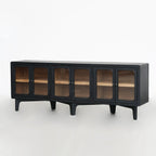Long low sideboard with dark timber finish and rounded glass doors revealing warm ash wood interior shelves.