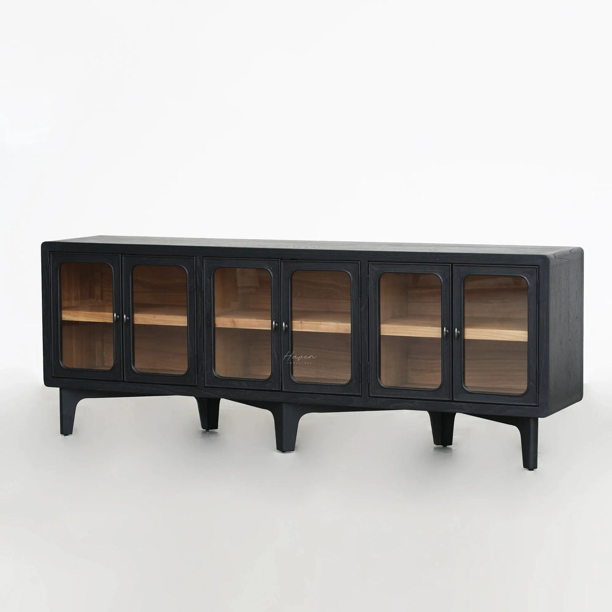 Long low sideboard with dark timber finish and rounded glass doors revealing warm ash wood interior shelves.