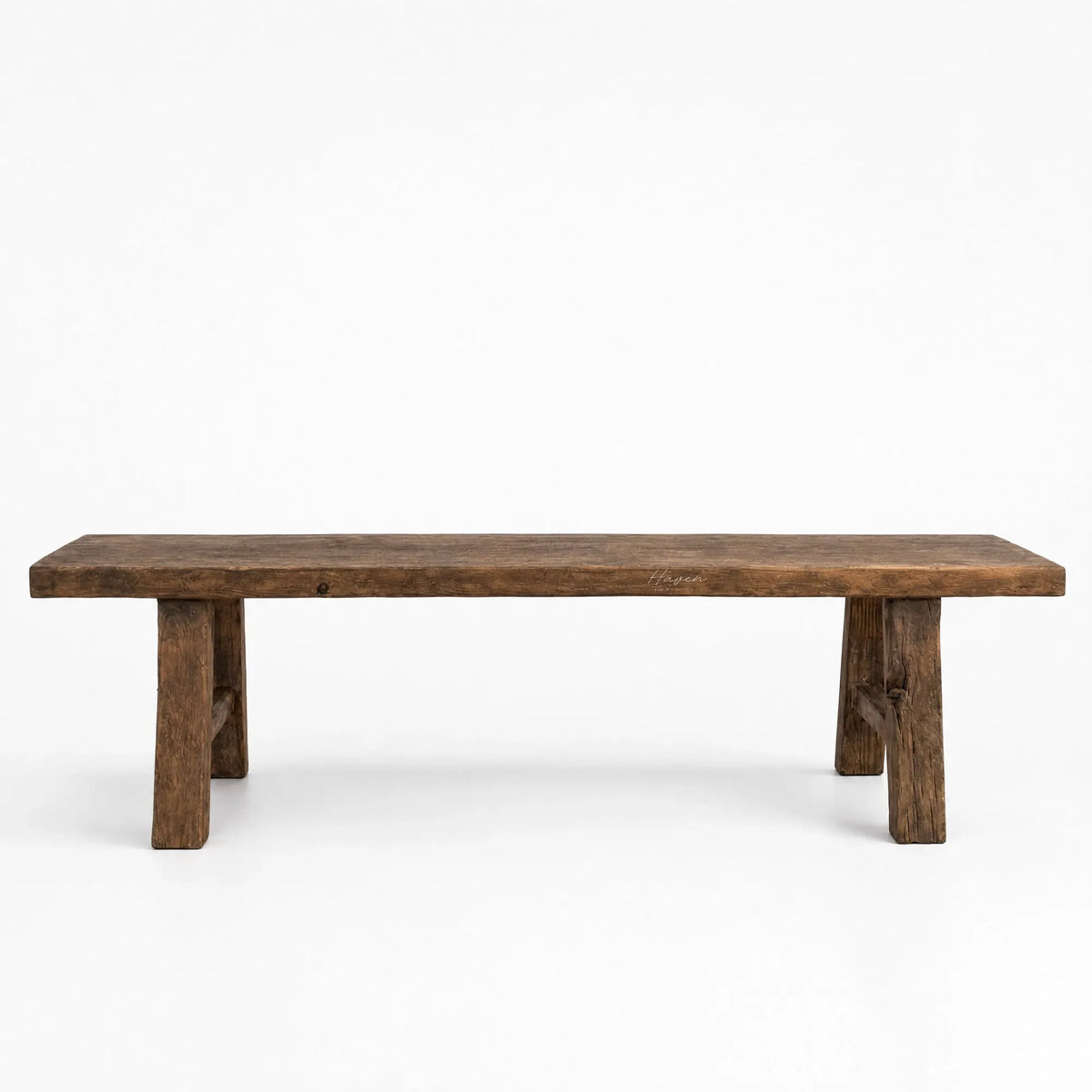 Reclaimed elm bench with broad seat, substantial legs, and visible grain knots against white background.