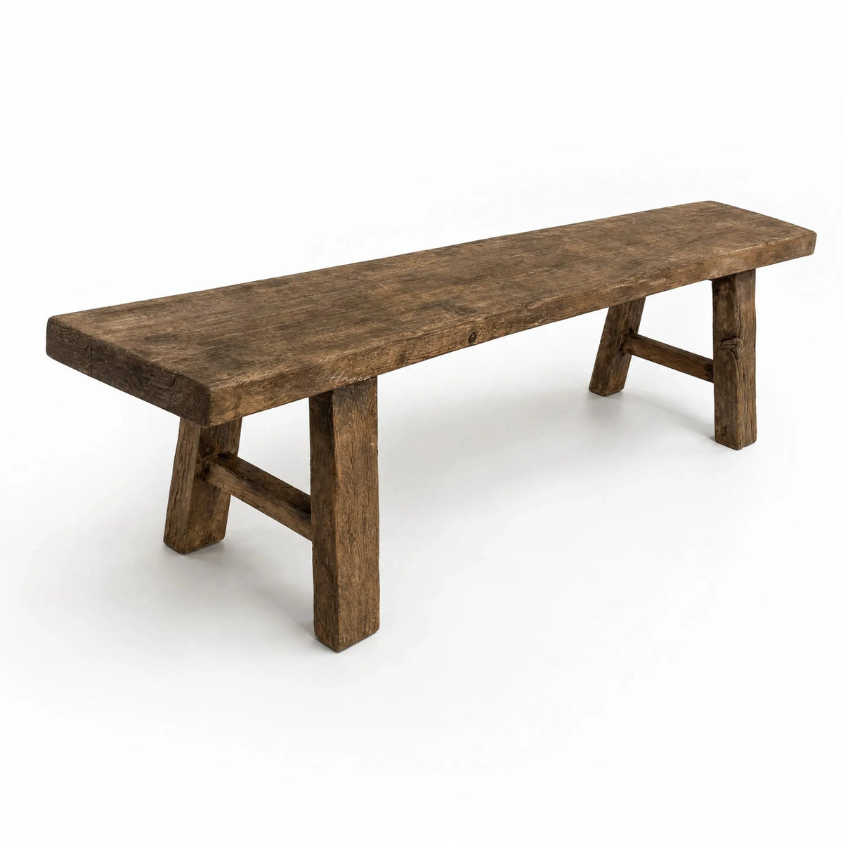 Long reclaimed elm bench with broad seat and substantial legs showcasing natural grain, knots, and irregular timber surface.
