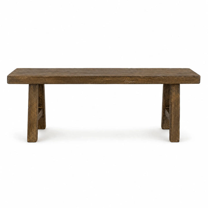 Reclaimed elm Estuary Bench featuring a broad seat, substantial legs, and a softly irregular surface with visible knots and grain.