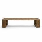Long reclaimed elm dining bench with substantial block supports, displaying raw texture, natural grain, and irregular surface details.