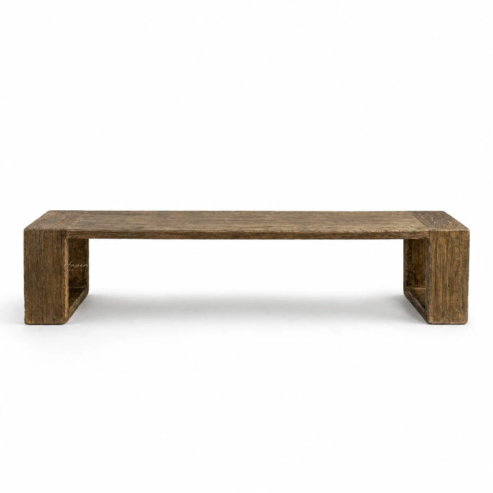 Long reclaimed elm dining bench with substantial block supports, displaying raw texture, natural grain, and irregular surface details.