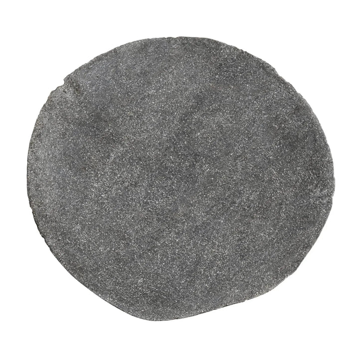 Riverstone plate with organic irregular edge and textured gray surface. Sculptural stone dinnerware with natural elemental character.