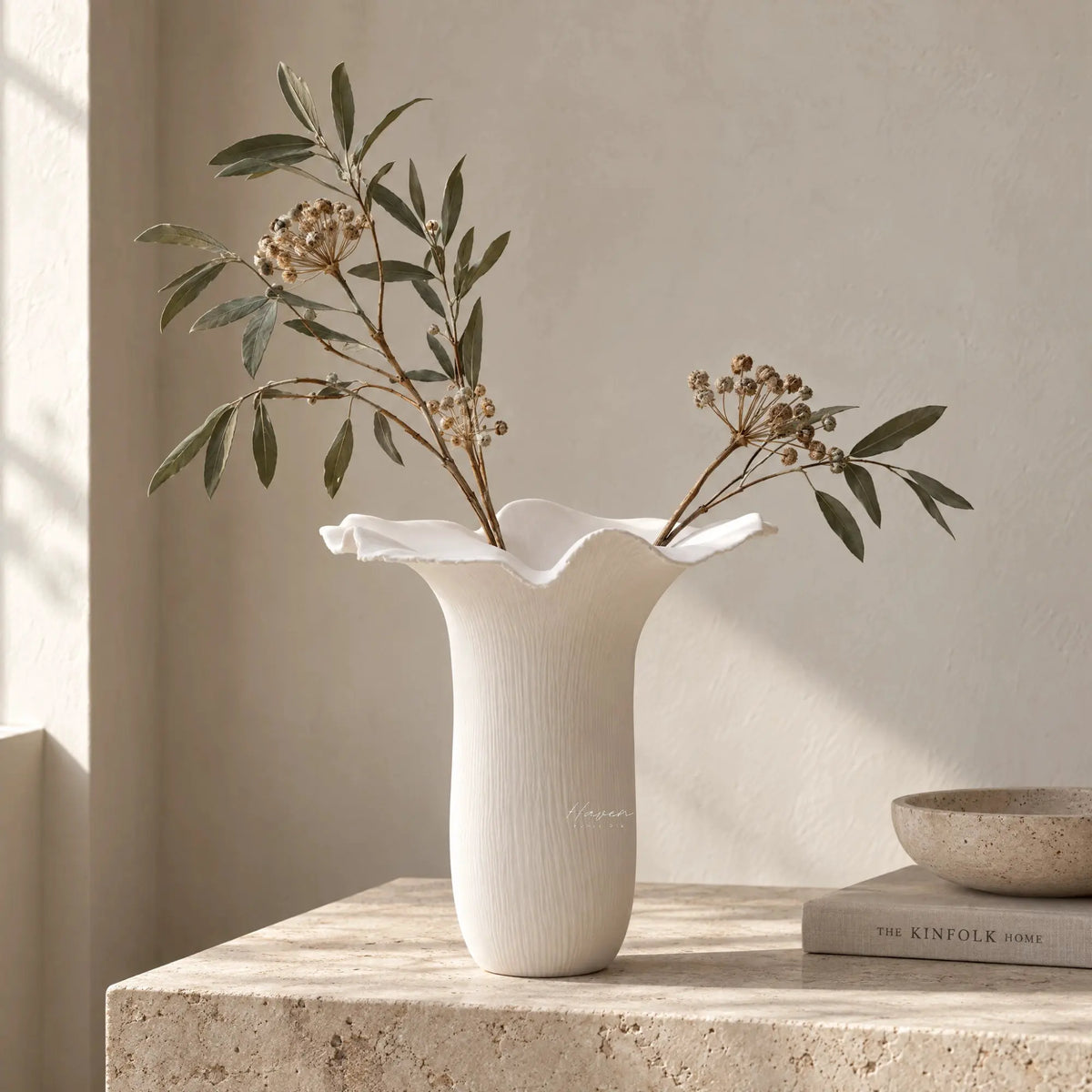White bone china Mushroom Vase XL features a sculptural floral silhouette with a undulating rim and subtle vertical texture holding dried branches.