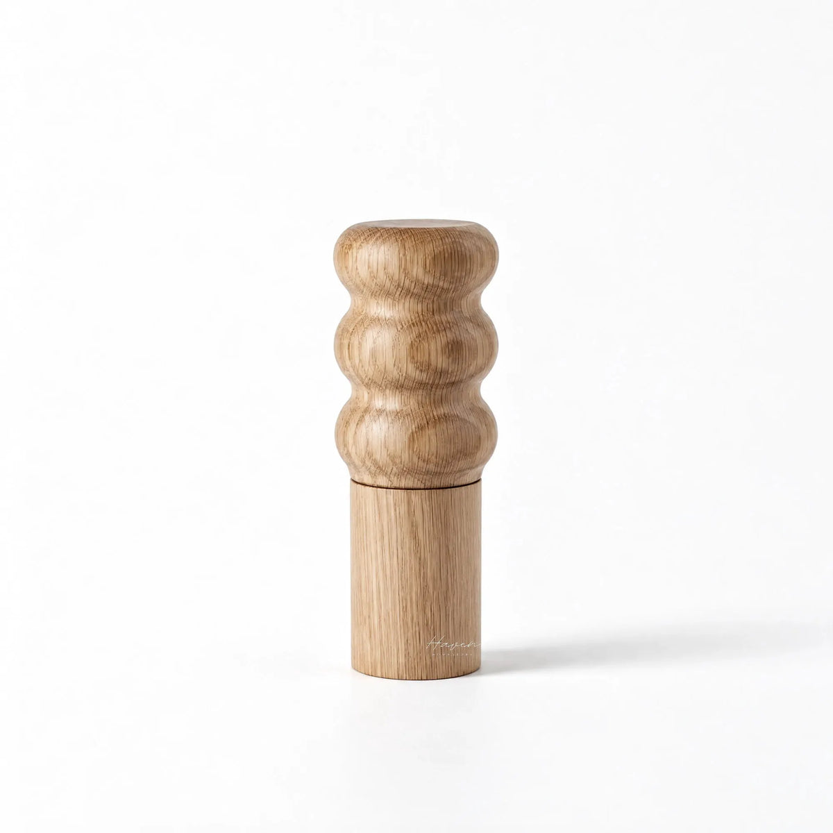 Natural oiled oak salt grinder with sculpted three-ring top and cylindrical base.