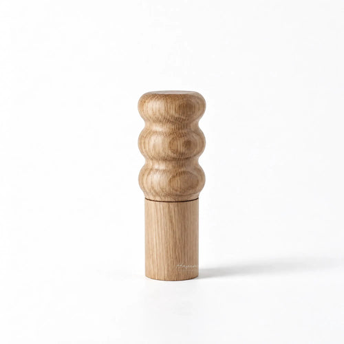 Natural oiled oak salt grinder with sculpted three-ring top and cylindrical base.