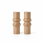 Oiled oak salt and pepper grinder set featuring a sculpted two-ring profile, rounded upper form, and cylindrical base.