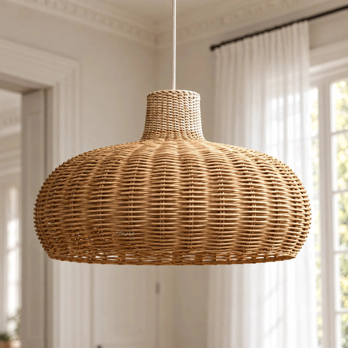 Handwoven peeled rattan pendant light with a low, domed profile and open texture, creating a warm, broad horizontal silhouette.