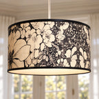 Drum pendant lightshade with textured bamboo finish and expressive black botanical floral motif, featuring a slim black metal rim.