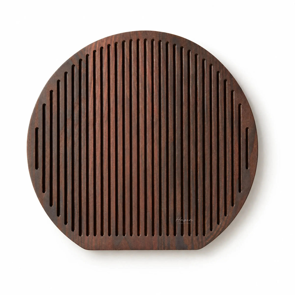 Round Yami cheese board with deep carbonised ash finish and rhythmic linear grooves for a sculptural serving presentation.