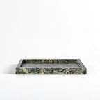 Rectangular green marble tray with deep veining and a low, architectural profile showcasing natural stone texture.
