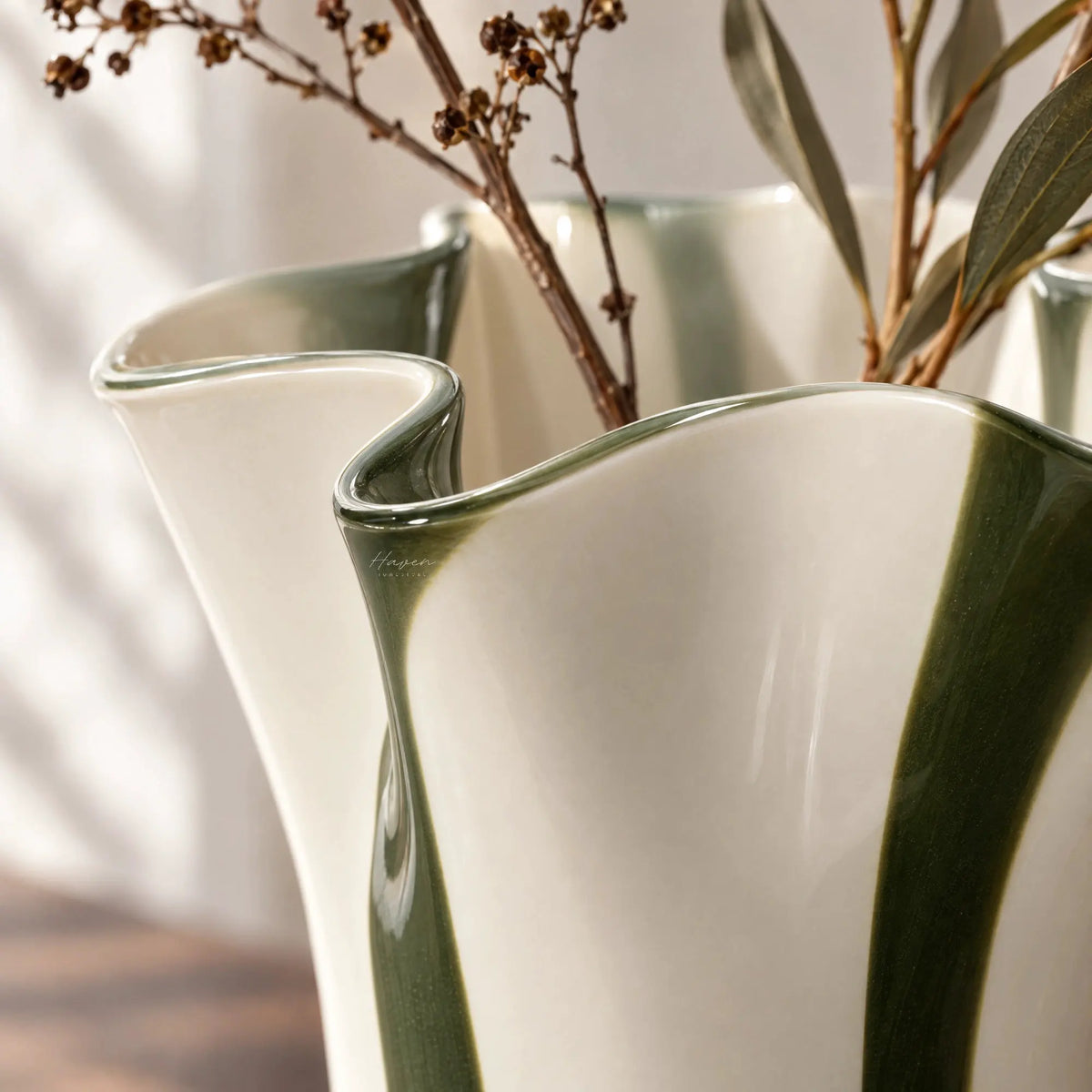 Mouthblown glass vase featuring a fluid, undulating rim and vertical stripes of hunter green against soft cream white.