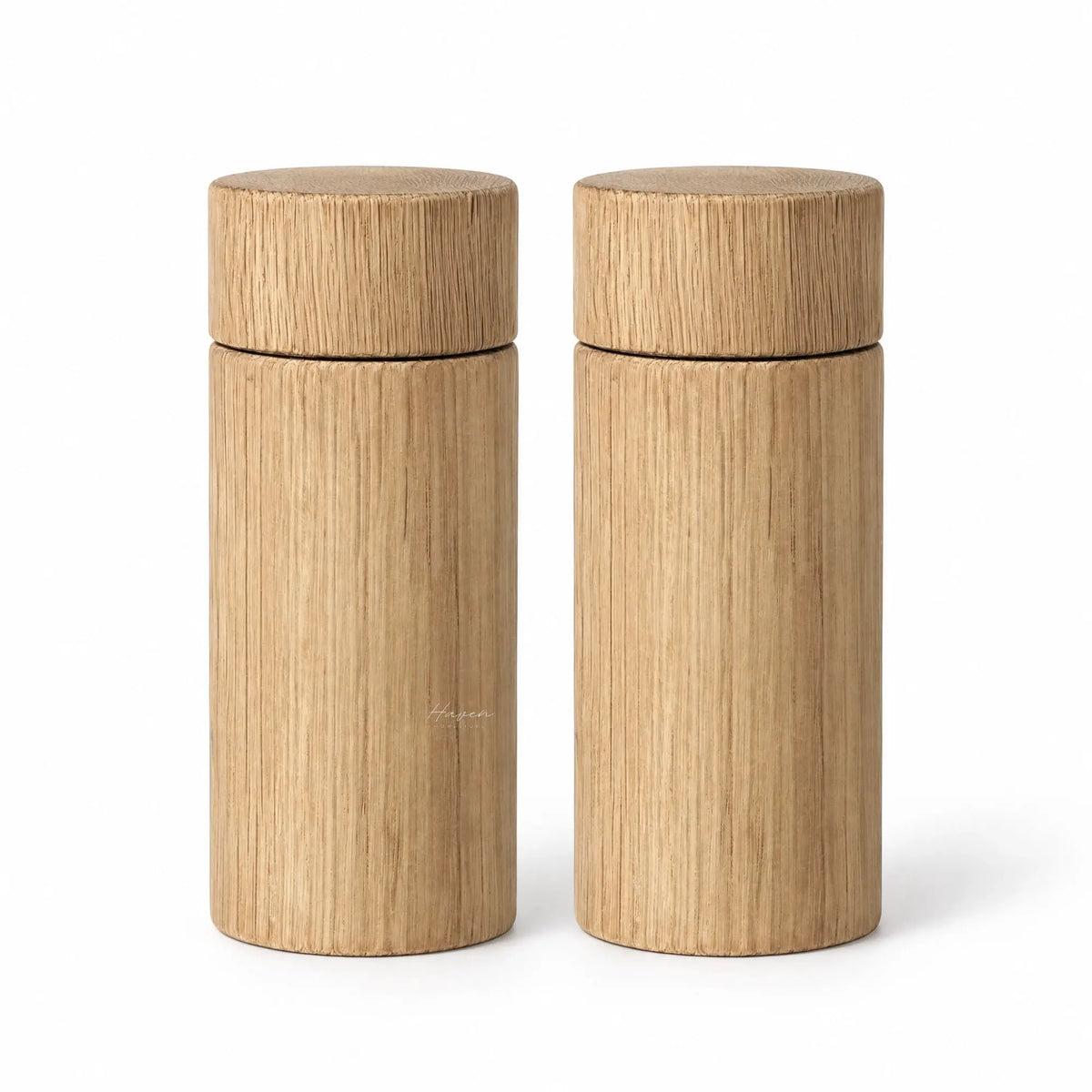 Set of two large cylindrical oak salt and pepper grinders featuring natural timber grain and a clean, minimalist profile.