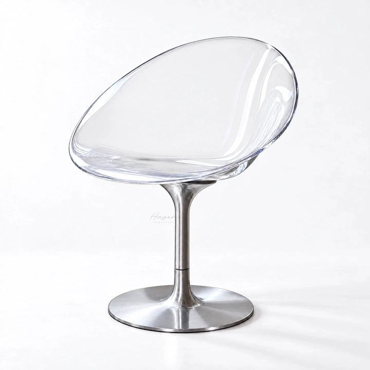 Modern clear polycarbonate swivel chair with a curved shell and slender aluminium pedestal base featuring a minimalist design.