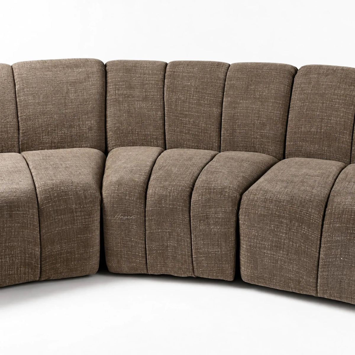 Curved Ethernet Modular Sofa in Truffle featuring softly segmented backrests and textured polyester upholstery with a low 70cm profile.