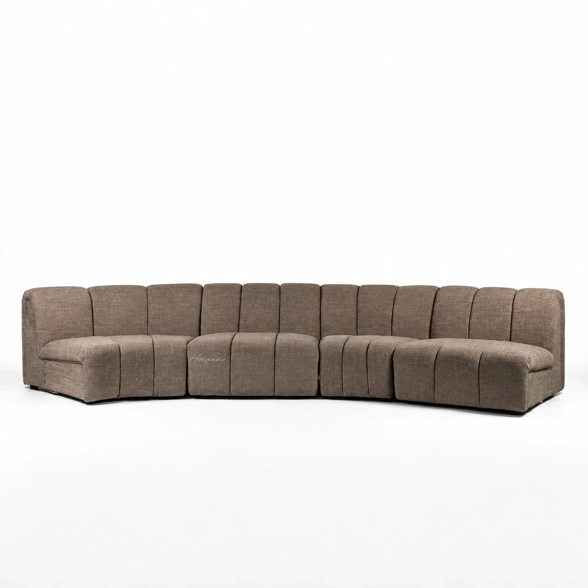 Long, low Arc Modular Sofa in Truffle featuring segmented textured polyester upholstery and a relaxed, curved architectural design.