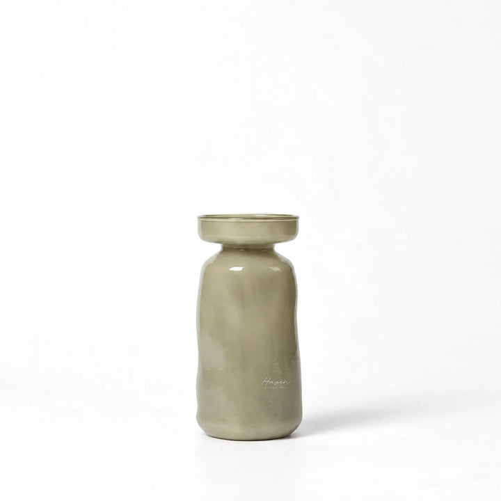 Mouthblown light green glass vase with a softly rounded silhouette, gently flared mouth, and muted translucency.
