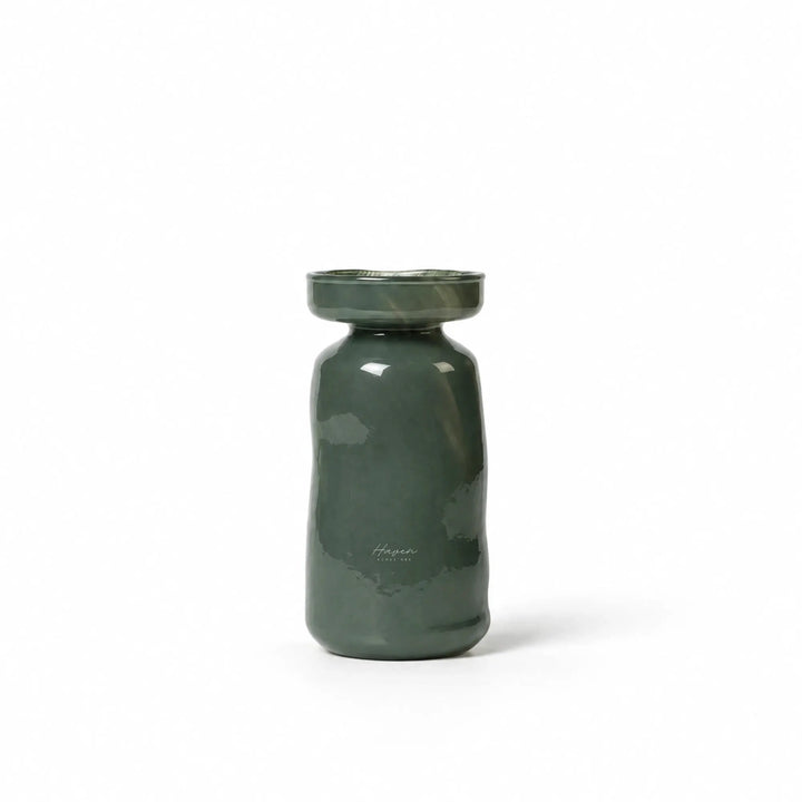 Dark green mouthblown glass vase with a softly rounded silhouette and gently flared mouth, featuring muted translucency.