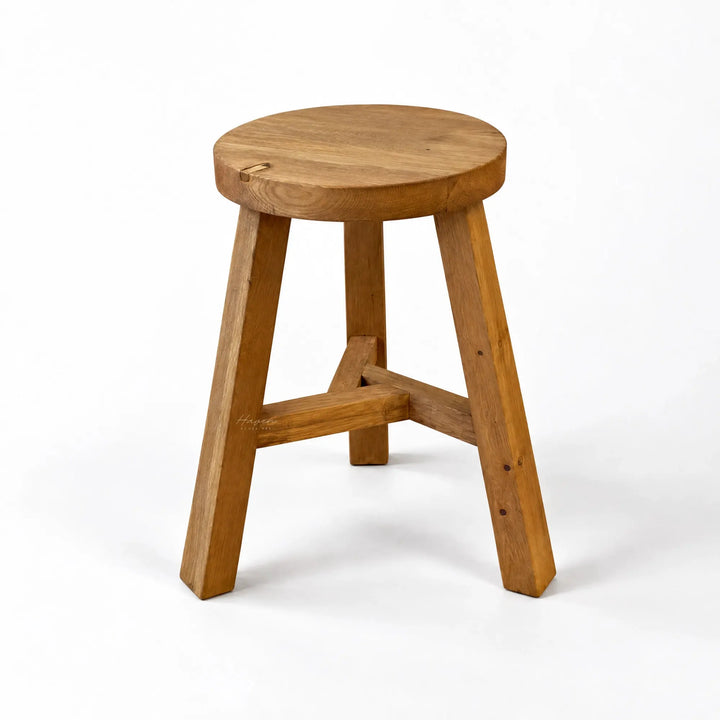 Reclaimed elm stool featuring a round seat, three angled legs, and visible cross bracing.