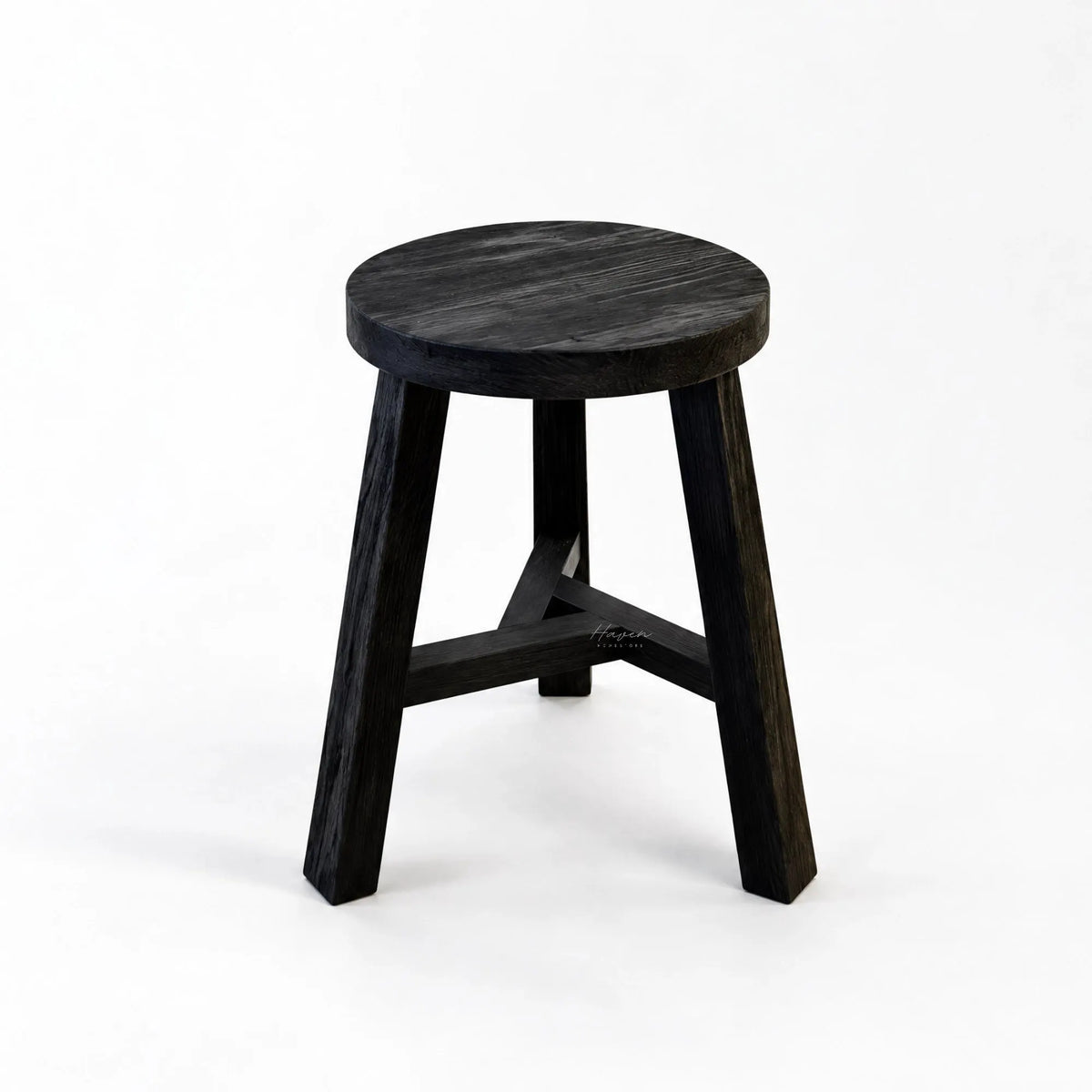 Black reclaimed elm stool with round seat, three angled legs, and cross supports showing natural grain.