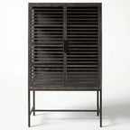 Kuro Slatted Cabinet in dark oak with glass panels behind slats, a warm, structured storage piece.