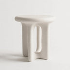 Yepa End Table with sculptural, curved form and architectural cut-out in matte linen GRC with stone-like texture.