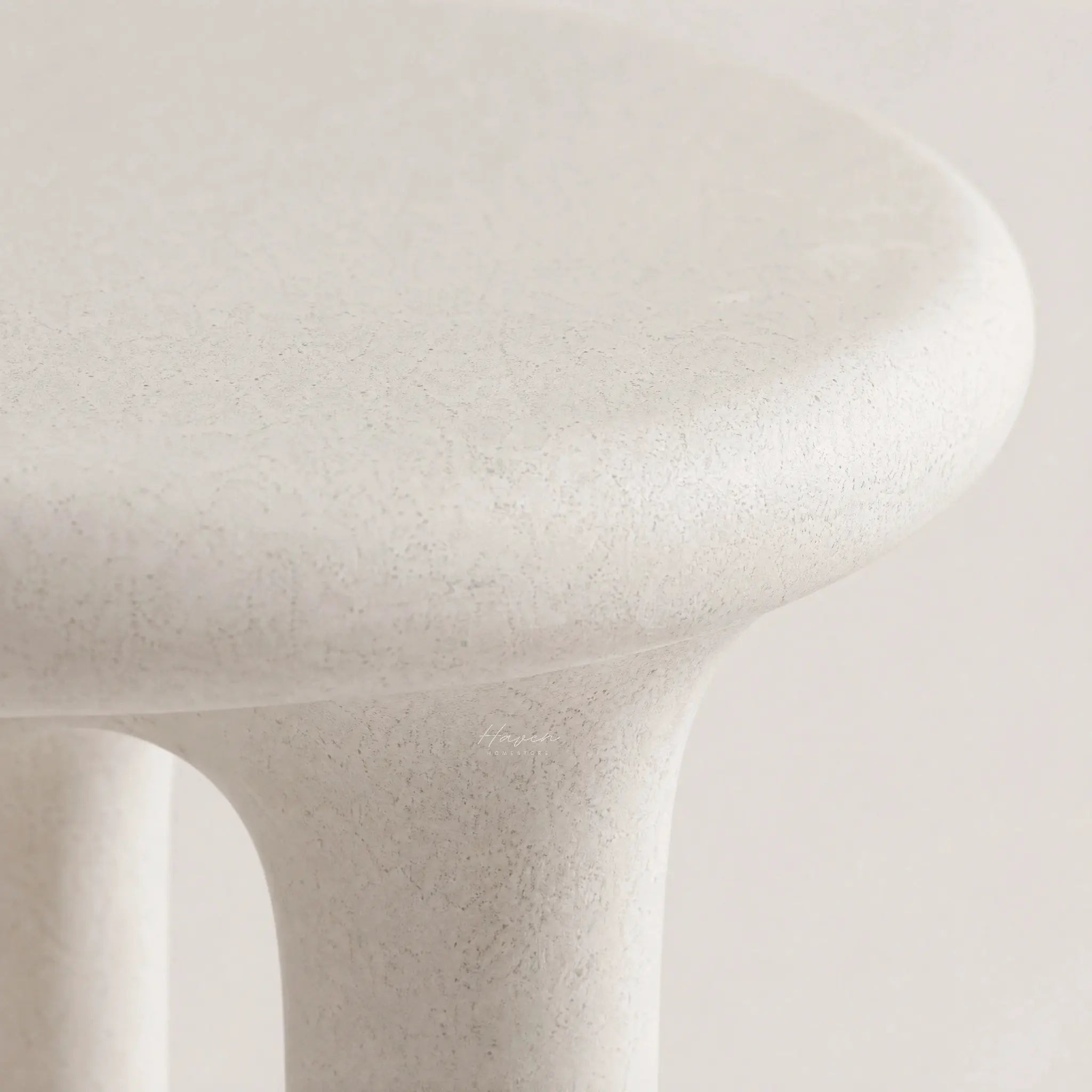 Yepa End Table with sculptural curves and architectural cut-out on matte linen-toned GRC surface with stone texture.