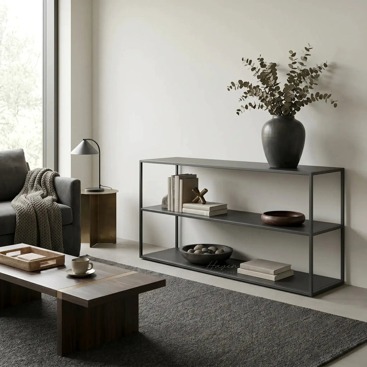 Studio Ellis Shelf in a minimalist living room with a dark metal frame, books, and a vase of eucalyptus.