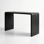Clarence Waterfall Console with burnt wood resin finish and continuous waterfall silhouette in a modern home