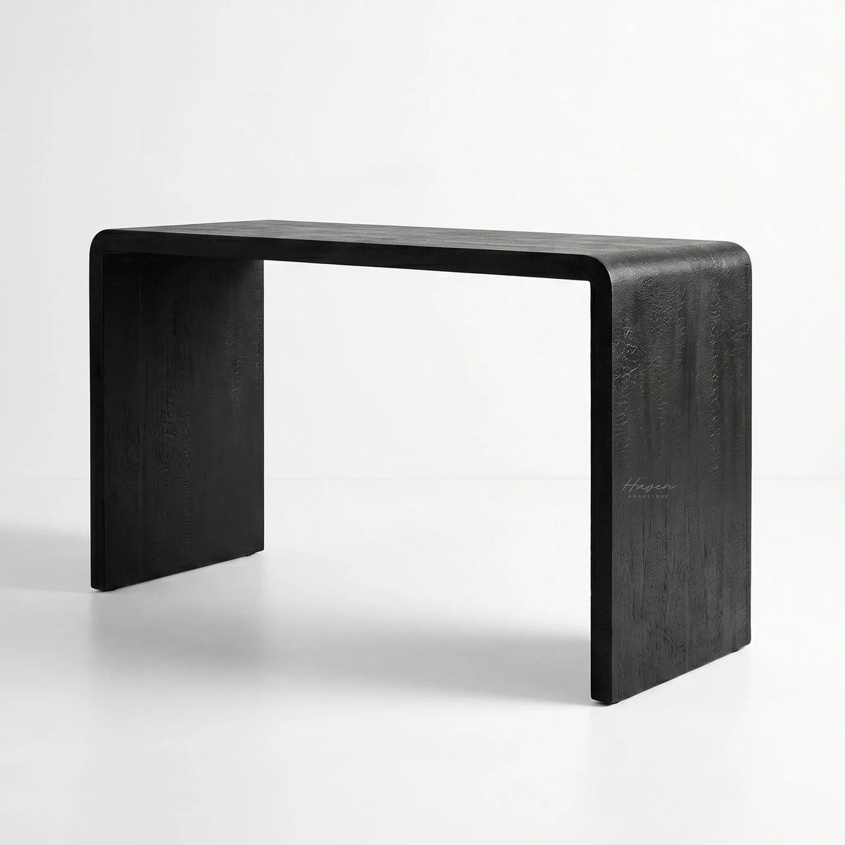 Clarence Waterfall Console with burnt wood resin finish and continuous waterfall silhouette in a modern home
