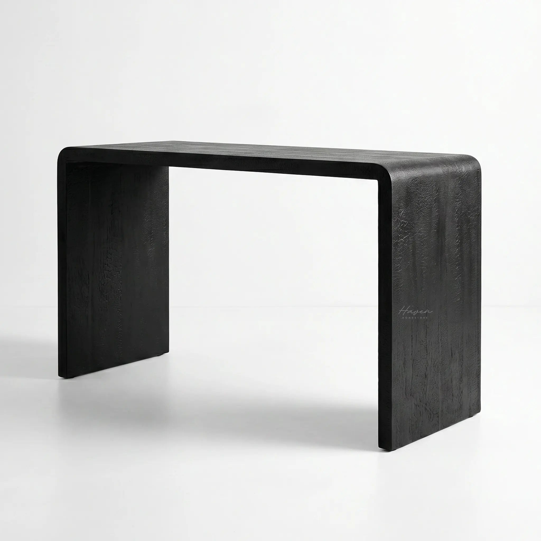 Clarence Waterfall Console with burnt wood resin finish and continuous waterfall silhouette in a modern home