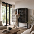 Kuro Slatted Cabinet: oak with glass panels behind slatted doors, warm, structured storage.